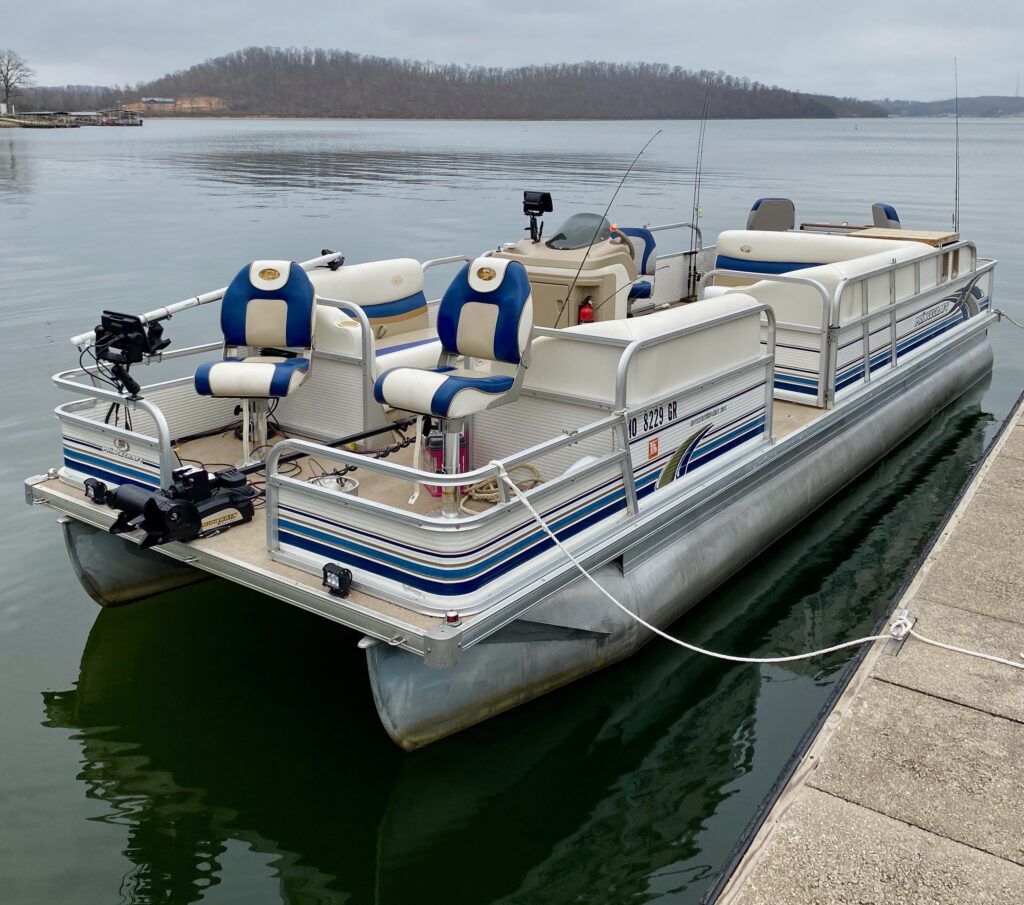 Overview of fishing pontoon with 4 swivel seats and bench seating electronics and electric motor